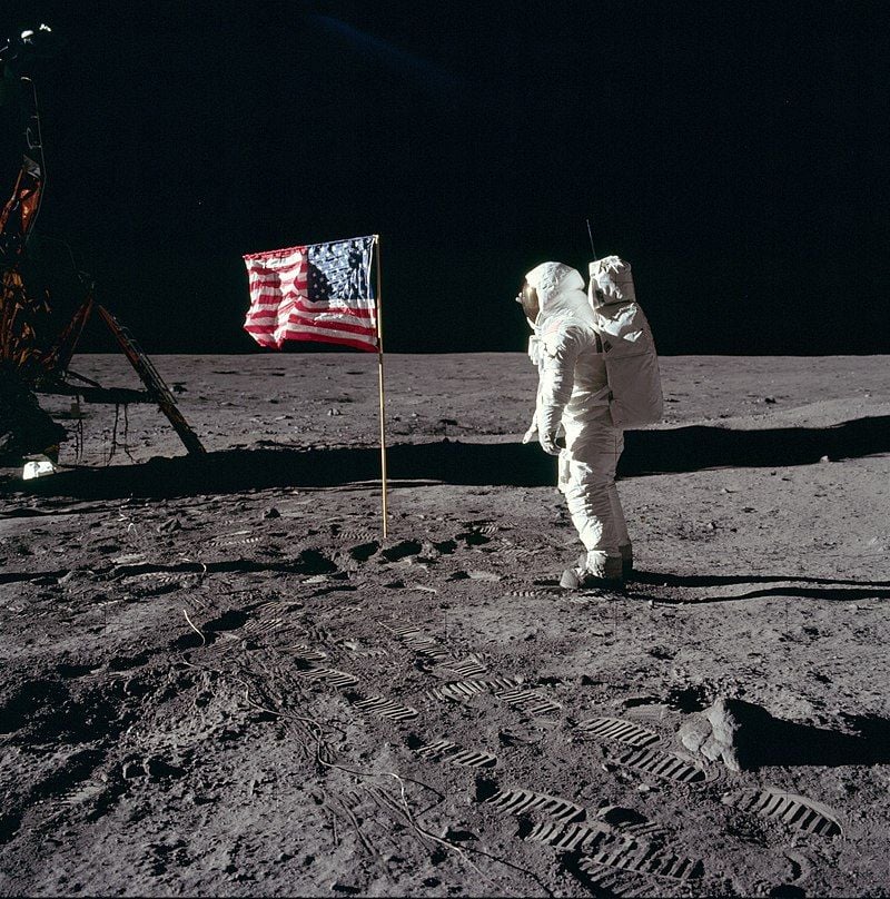 Astronaut Buzz Aldrin saluting the US flag on the surface of the moon