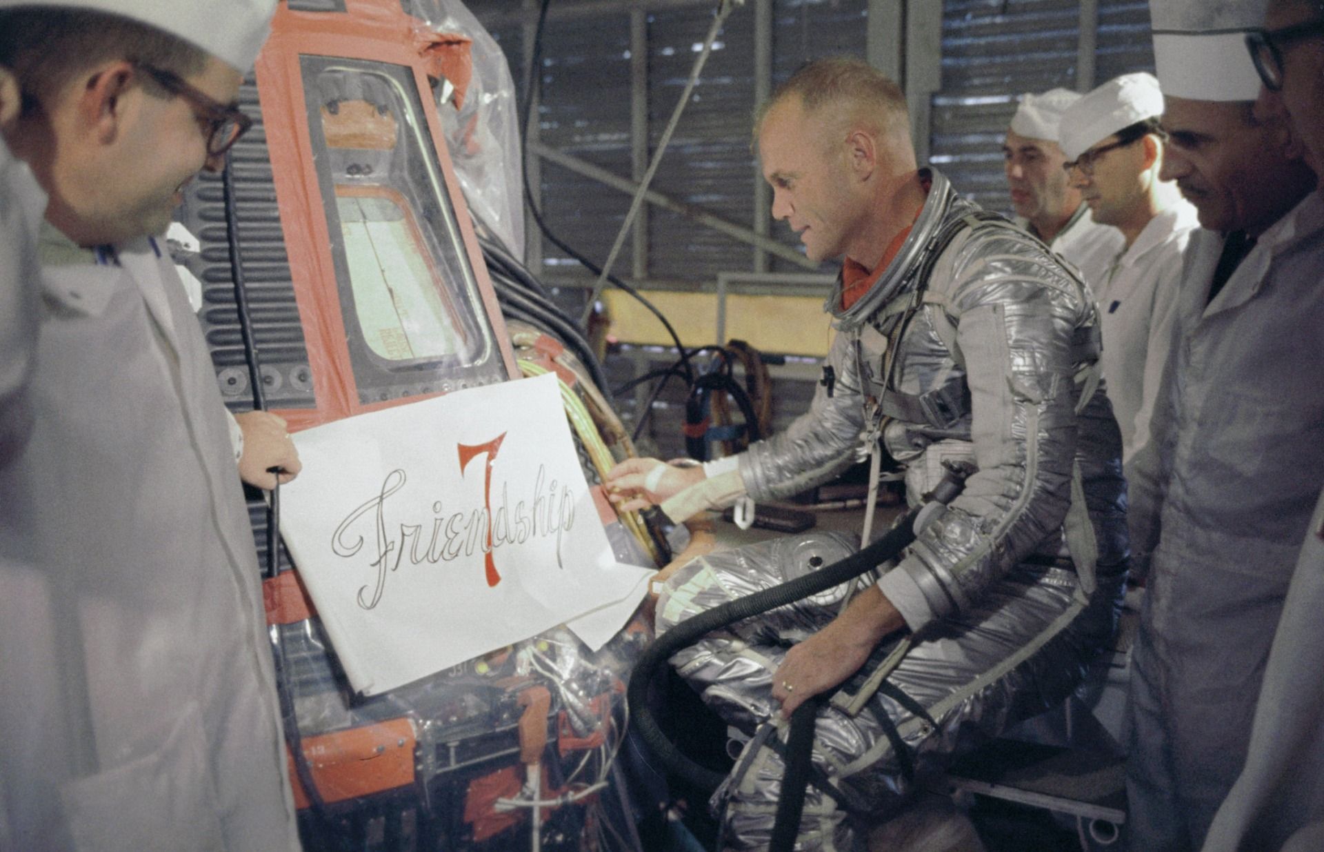 John Glenn looking at Friendship 7 noseart