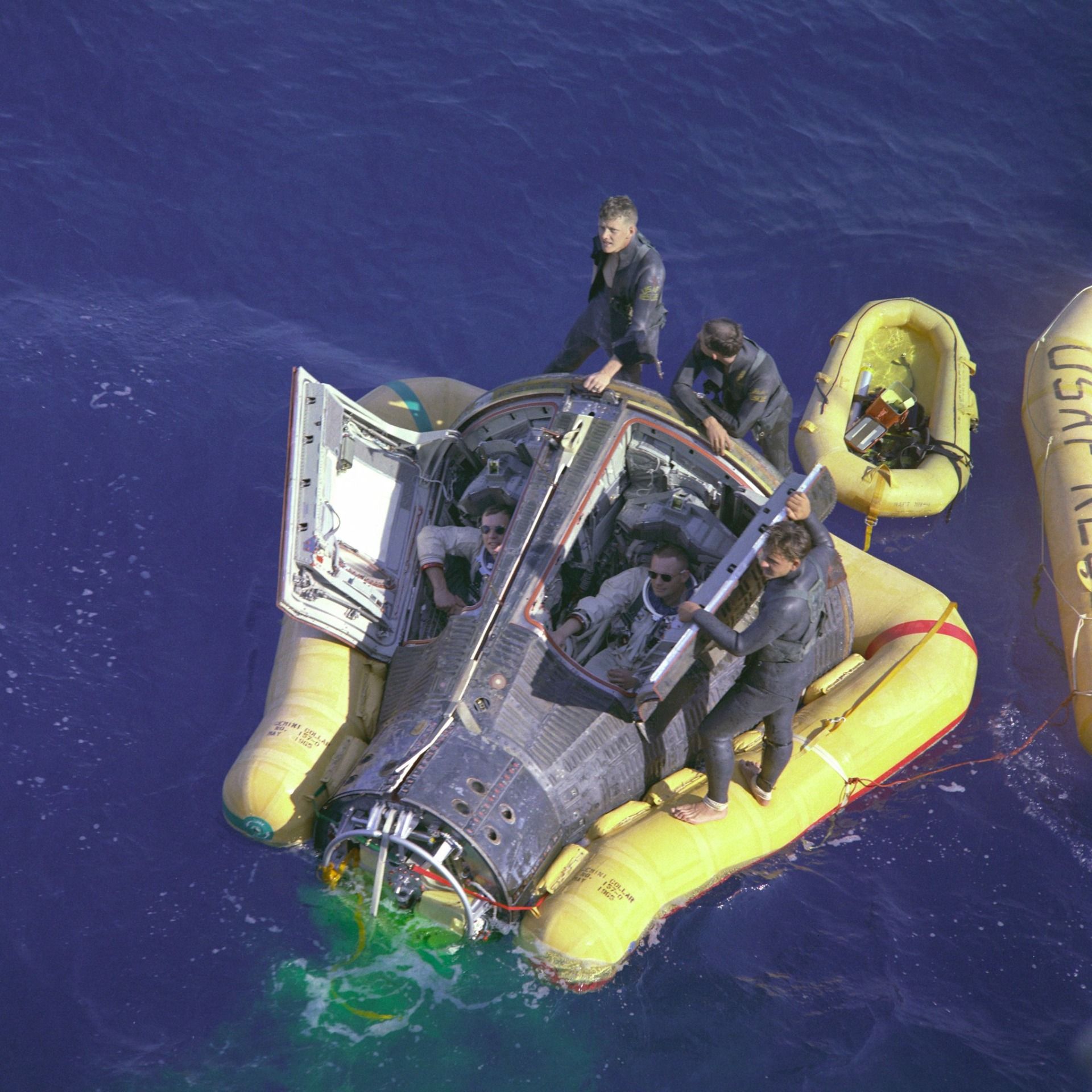 Astronauts and pararescuers in Gemini 8 capsule after splashdown