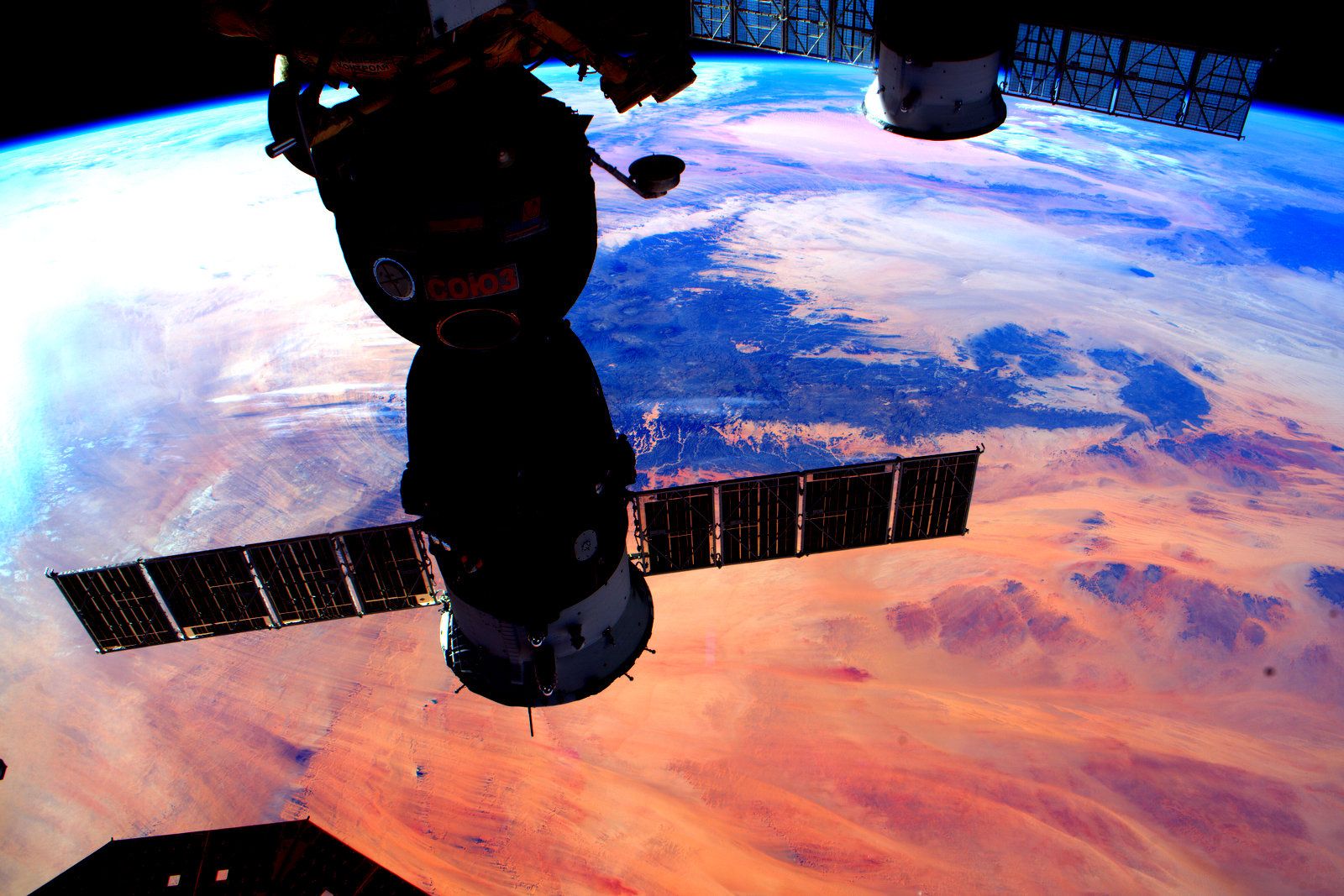 Sunset on Earth behind Soyuz spacecraft docked at ISS